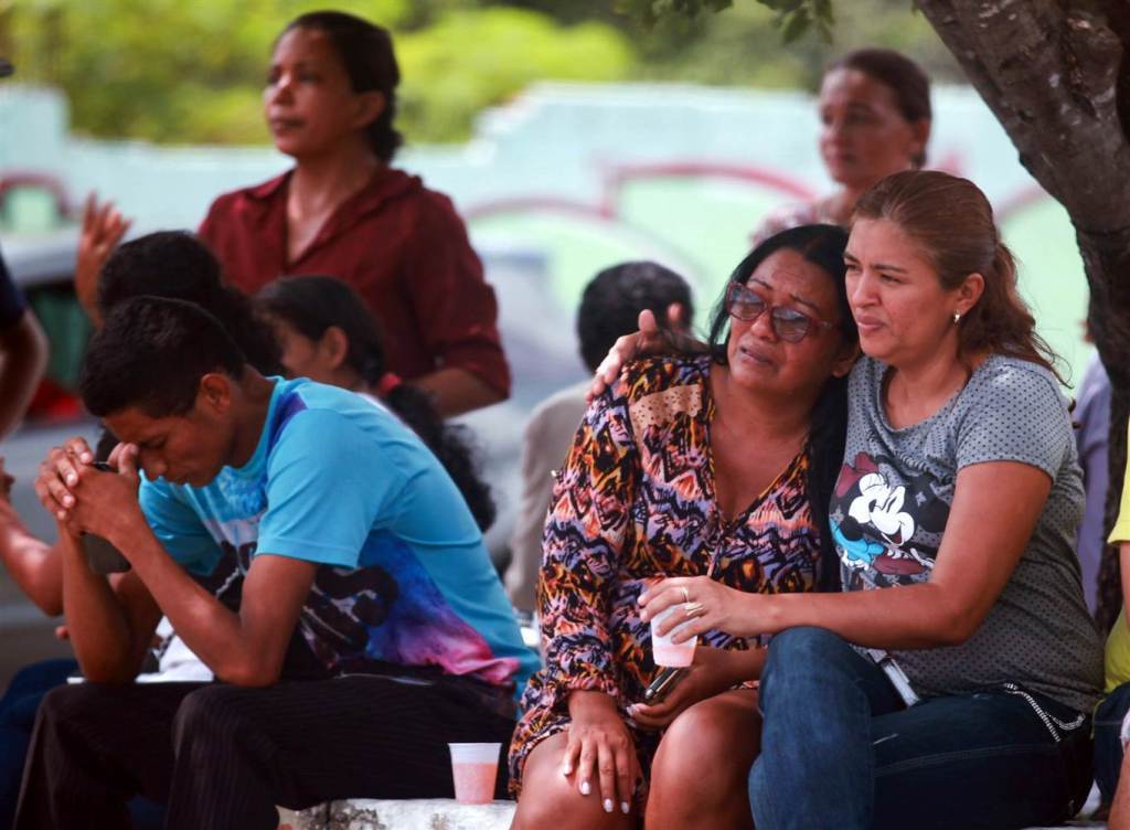Relatives of prisoners await news after a bloody prison riot Monday in the Amazon jungle city of Manaus, Brazil. Michael Dantas / Reuters.
