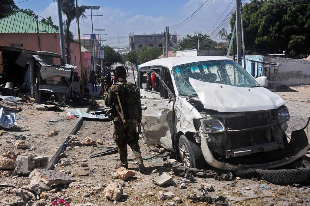 A Somali soldier stands at the scene of a car bomb attack near the Peace Hotel of the capital Mogadishu, on January 2, 2017. Twin suicide car bombs claimed by the Al-Qaeda aligned Shabaab insurgent group wounded nine people today at the entrance to Mogadi