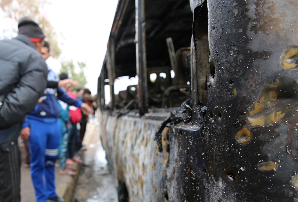 BAGDAD, IRAQ - JANUARY 2: People gather around a wrecked vehicle following a blast, caused by a bomb-laden vehicle, at 55th Square in Sadr Region of Baghdad, Iraq on January 2, 2017. Scores of casualties reported. File Photo: AA.