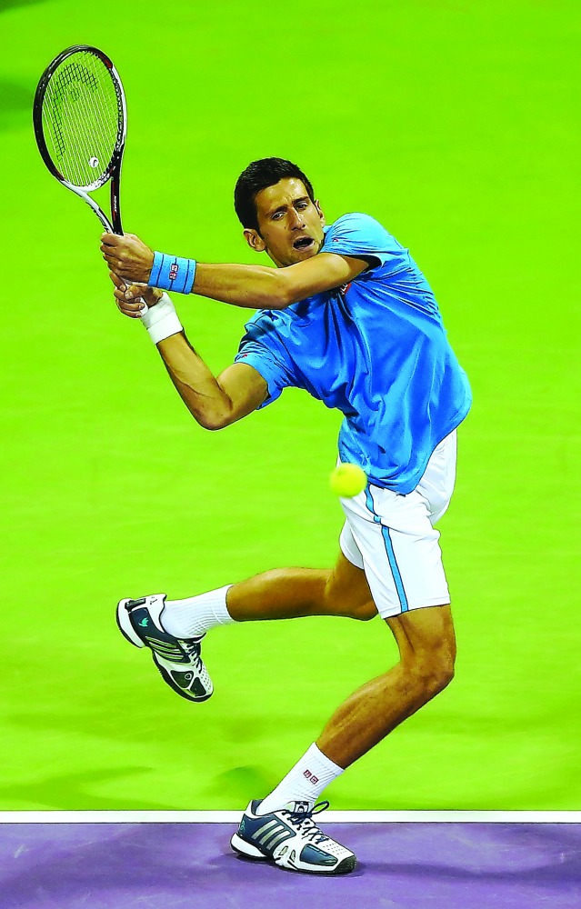 Serbia's Novak Djokovic celebrates after beating Spain's Fernando Verdasco in their ExxonMobil Qatar Open semi-final at the Khalifa International Tennis and Squash Complex yesterday. Djokovic won a thrilling match 4-6, 7-6 (9/7), 6-3 to progress to his se