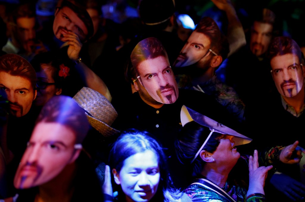 Fans of the late George Michael wear masks at a tribute night event, in London, Britain, January 6, 2017. REUTERS/Peter Nicholls

