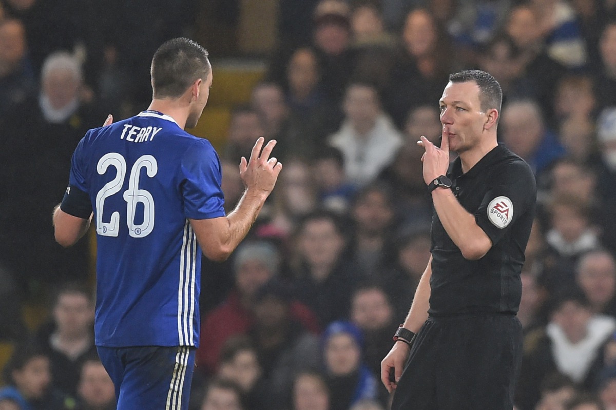 Chelsea's English defender John Terry (L) reacts just before Kevin Friend shows him a red card after a challenge on Peterborough United's English striker Lee Angol during the English FA Cup third round football match between Chelsea and Peterborough at St