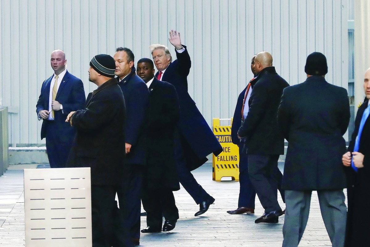US President-elect Donald Trump (centre) exits One World Trade Center following a meeting in Manhattan, New York City, US.