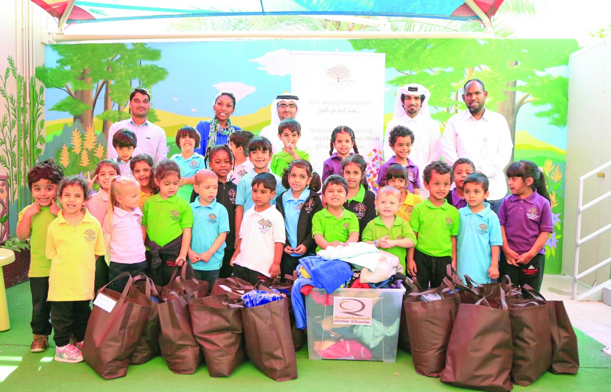 Schoolchildren with in-kind donations provided to QC for poor workers.