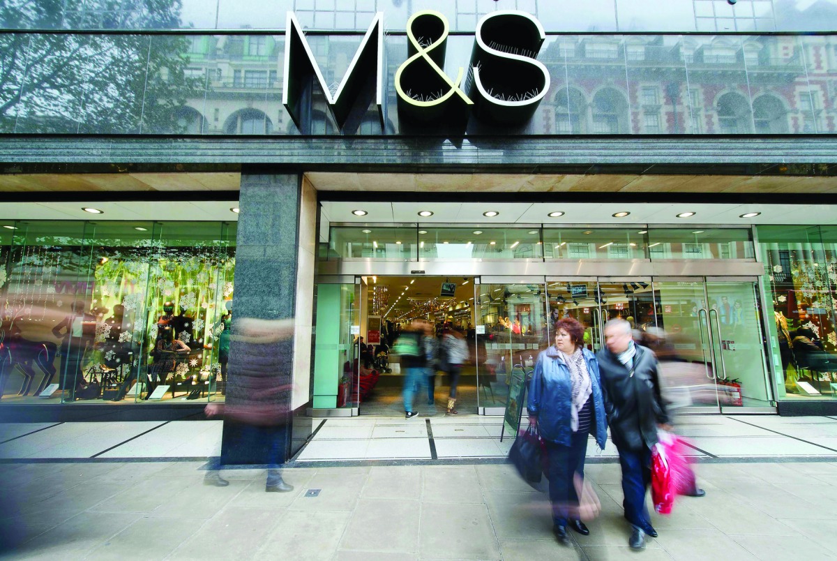  This file photo taken on November 06, 2012 shows people walking past a Marks & Spencer store in central London on November 6, 2012. British food-to-clothing retailer Marks and Spencer announced a share price jump of 2.7 percent after the group revealed a