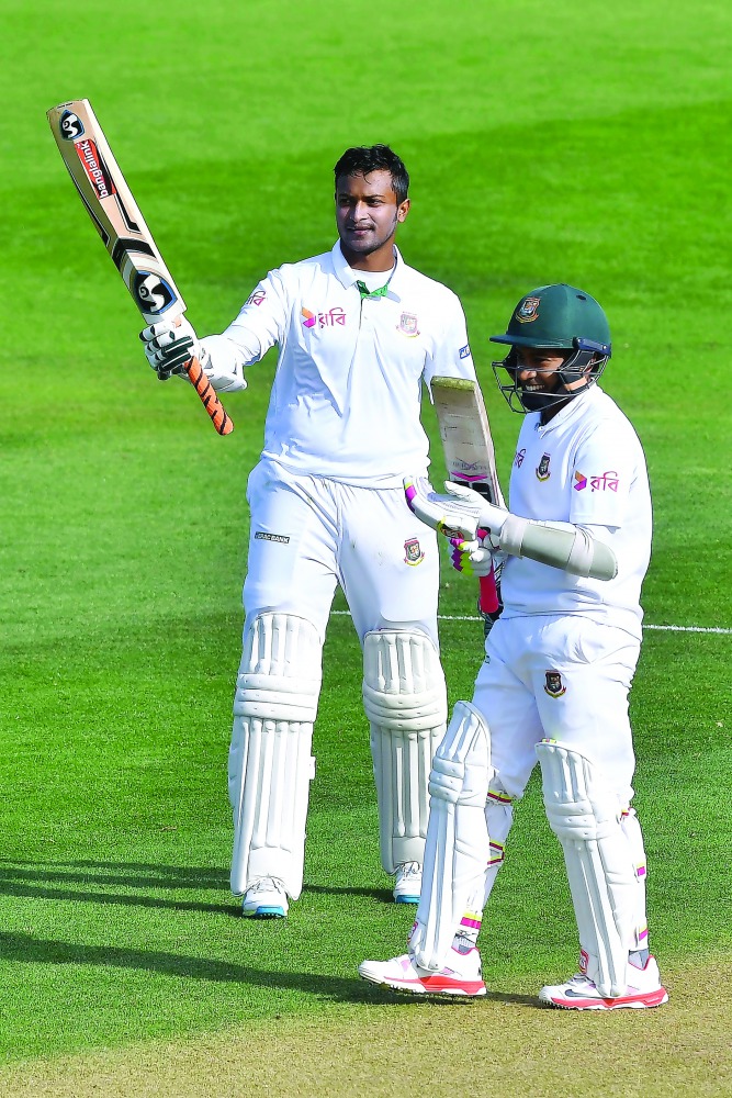 Bangladesh's Shakib Al Hasan (left) celebrates after scoring a double century against New Zealand while with team mate Mushfiqur Rahim looks on during day two of the first Test at the Basin Reserve in Wellington yesterday.