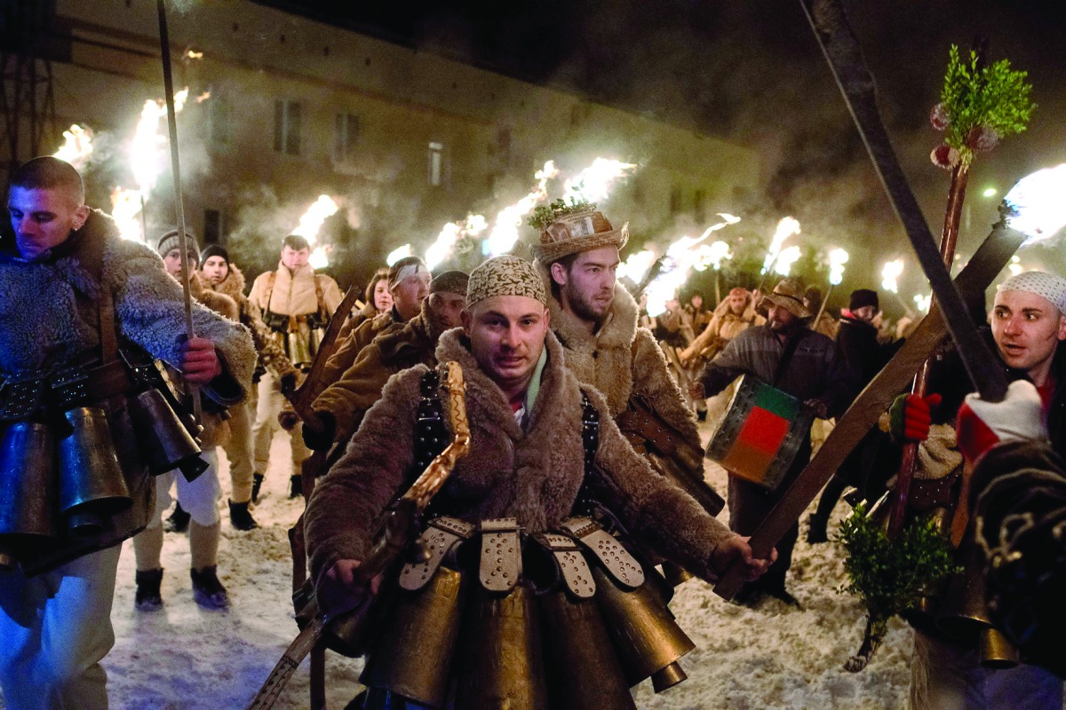 Bulgarian dancers dressed as animals perform a ritual dance with flaming torches during the Kukeri Carnival in the village of Batanovtsi, western Bulgaria, on January 13, 2017. The Kukeri Carnival is a festival of brightly colored masks and costumes which