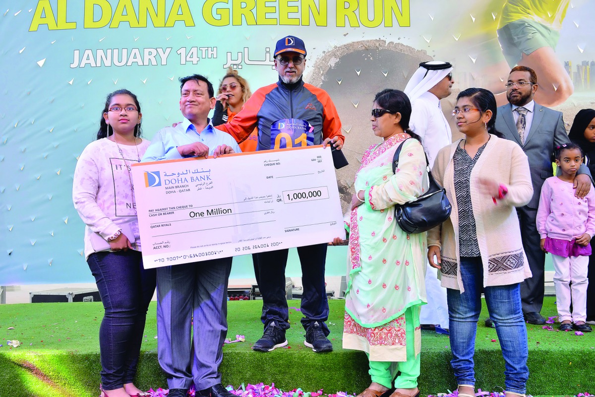 Dr R Seetharaman, CEO of Doha Bank, giving away the prize to an Al Dana millionaire.