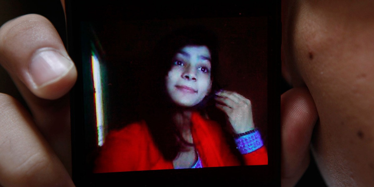 Police said 18-year-old Zeenat Rafiq (shown in the mobile phone screen ) married Hassan Khan (who holds the phone) and eloped to live with his family a week before she was killed. (AFP file photo) 