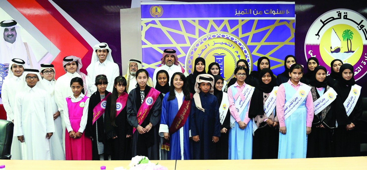 Officials of Education Excellence Awards, Dr Hamda Al Sulaiti, Chairperson, Development Committee, Ministry of Education and Higher Education; and Hassan Al Mohammadi, Chairman, Executive Committee, and Director, Public Relations at the Ministry, pose wit