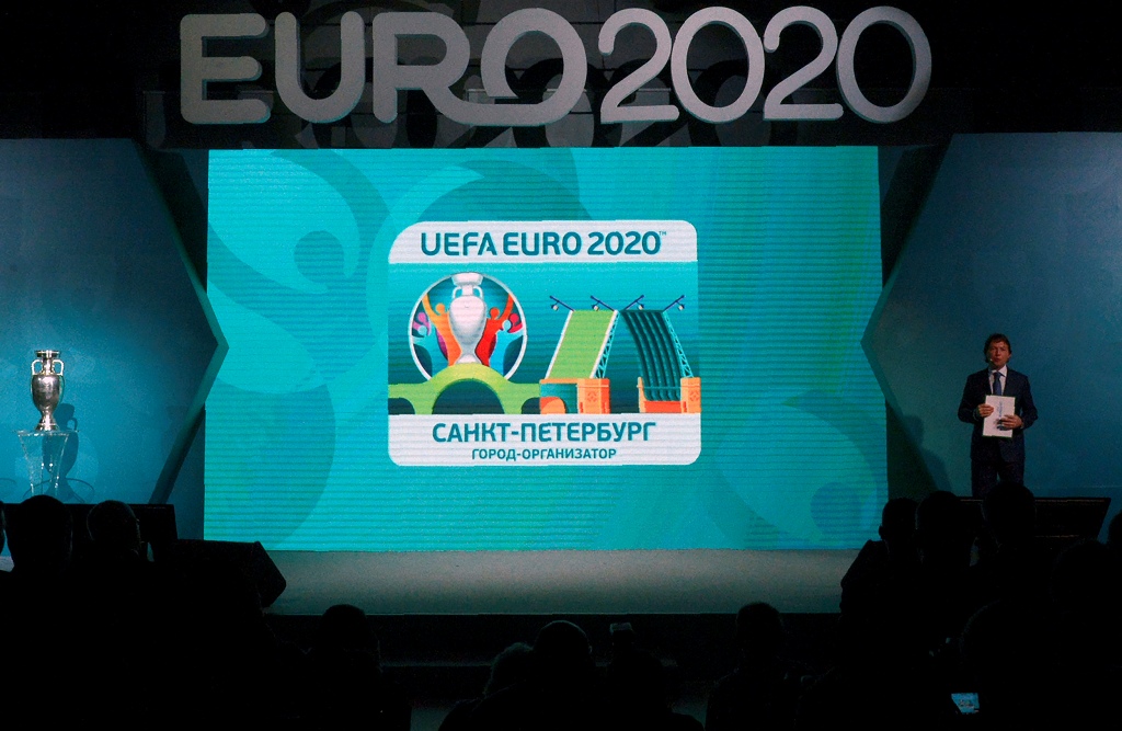 The UEFA EURO 2020 host city Saint Petersburg logo is seen on a screen during its launch in Saint Petersburg on January 19, 2017. The EURO 2020 UEFA European Championship will see matches hosted in 13 cities across Europe, with the semi-finals and final s