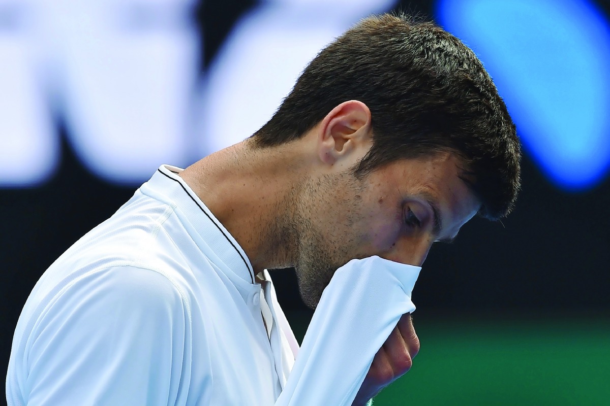 Serbia's Novak Djokovic reacts during the men's singles match of the Australian Open tennis tournament in Melbourne on Thursday. Djokovic lost 7-6 (8), 5-7, 2-6, 7-6 (5), 6-4 to No. 117-ranked Istomin.  