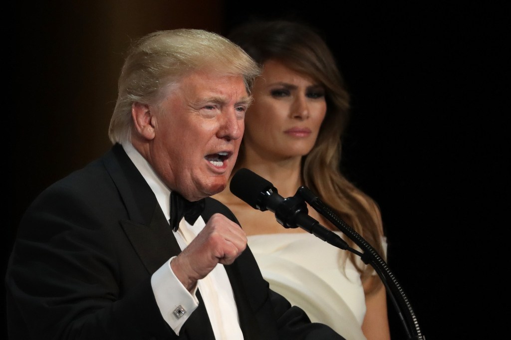 (L-R) President Donald Trump speaks as his wife First Lady Melania Trump looks on during A Salute To Our Armed Services Inaugural Ball at the National Building Museum on January 20, 2017 in Washington, DC. Alex Wong/AFP
