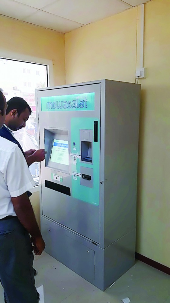 People using the self-service machine for Karwa smart cards at Al Ghanim Central Bus Station in Doha.