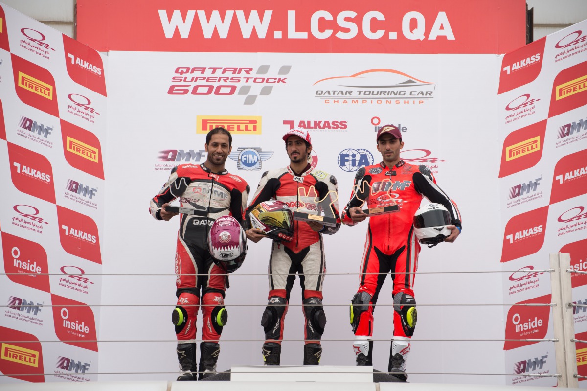 Mishal Al Naimi (centre), winner of race 1 and 2 of the first round of the Qatar Superstock 600 series, poses for a picture along with second and third place winners Sultan Al Sulaiti and Nasser Al Malki at the Losail International Circuit yesterday.
