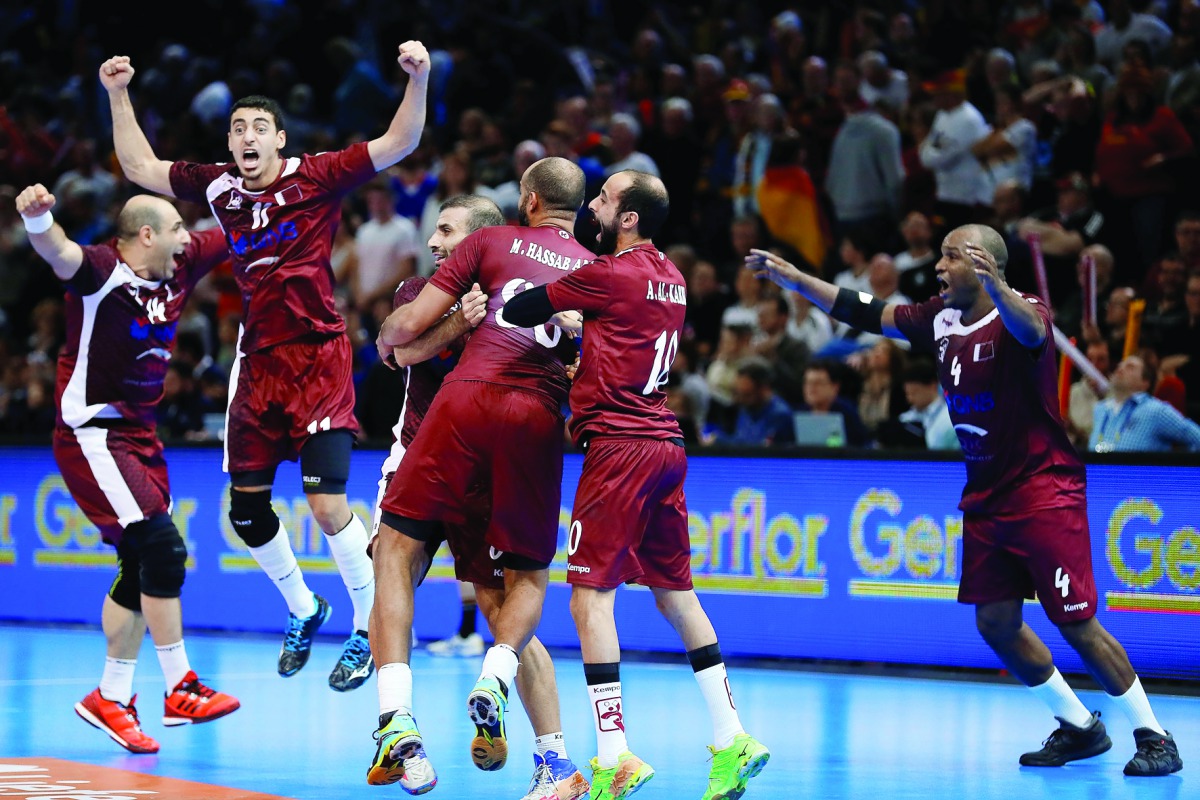 Qatar's Bassel Alrayes (left), Murad Abdulrazzaq (second left), Hassan Mabrouk (right) and team-mates celebrate after they defeated Germany to enter the quarter-finals of the 25th IHF Men's World Championship Handball match at the AccorHotels Arena in Par