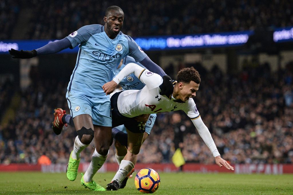 Manchester City's Ivorian midfielder Yaya Toure (L) vies with Tottenham Hotspur's English midfielder Dele Alli during the English Premier League football match between Manchester City and Tottenham Hotspur at the Etihad Stadium in Manchester, north west E