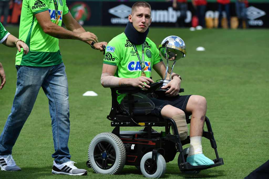 Brazilian Chapecoense goalkeeper Jackson Follmann, a survivor of the LaMia airplane crash in Colombia, holds the Copa Sudamericana trophy at the Arena Conda stadium in Chapeco, Santa Catarina state, in southern Brazil on January 21, 2017, before a friendl