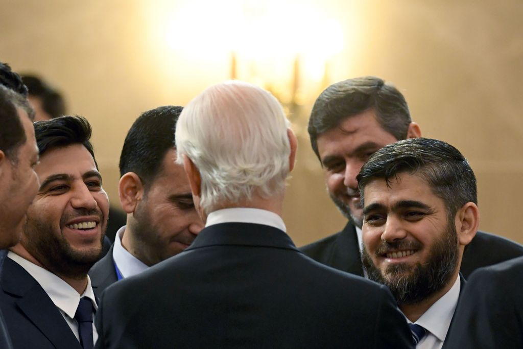 Chief opposition negotiator Mohammad Alloush (R) of the Jaish al-Islam (Army of Islam) rebel group listens to UN envoy for Syria Staffan de Mistura prior to the first session of Syria peace talks at Astana's Rixos President Hotel on January 23, 2017. / AF