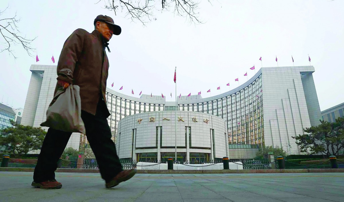 A man walks past the People's Bank of China (PBOC) headquarters in Beijing.