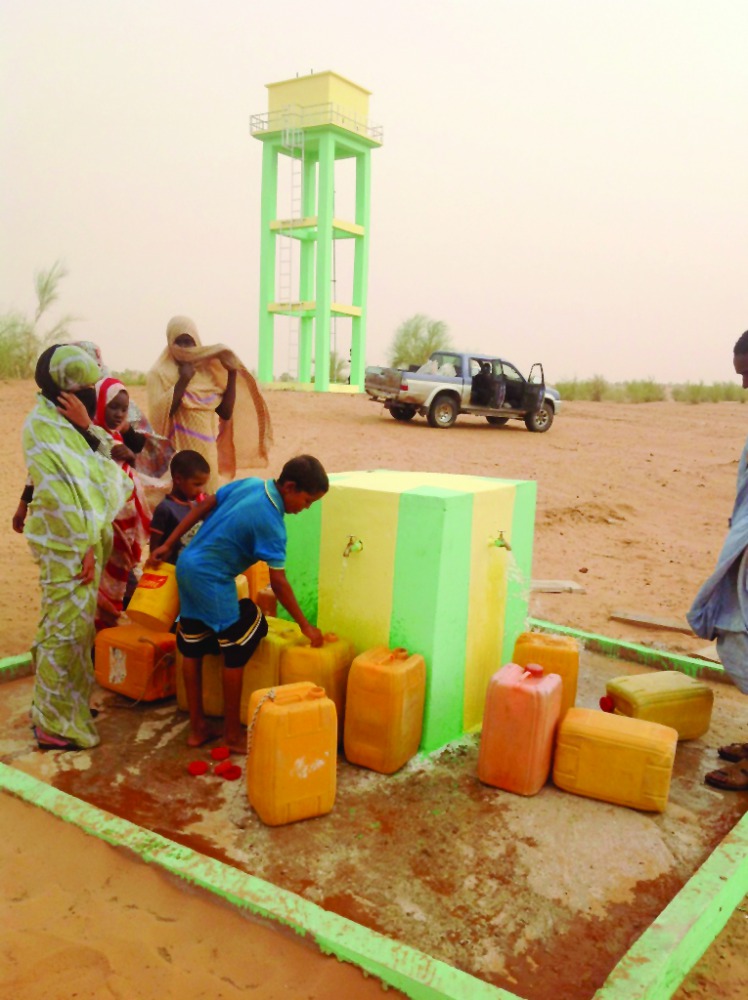 Villagers collecting water from a water project built by Qatar Charity in Mauritania.