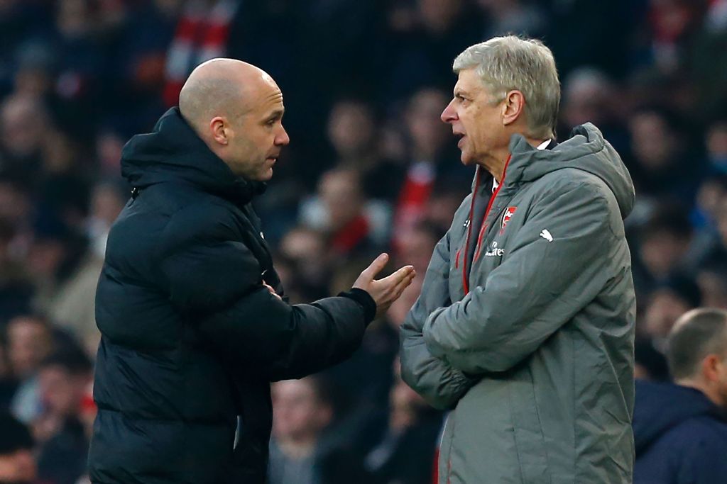 (FILES) In this file photo taken on January 22, 2017 Fourth official Anthony Taylor (L) points Arsenal's French manager Arsene Wenger (R) to the tunnel after he was sent off by English referee Jonathan Moss (not pictured) during the English Premier League