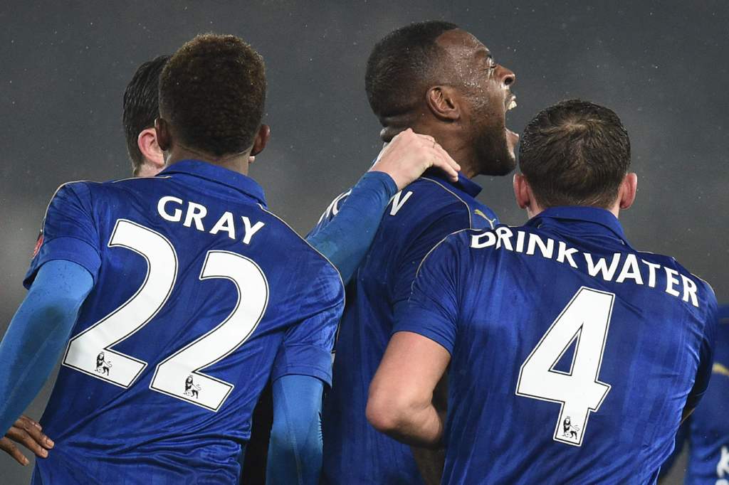 Leicester City's English-born Jamaican defender Wes Morgan (C) celebrates with Leicester City's English midfielder Demarai Gray (L) and Leicester City's English midfielder Danny Drinkwater (R) after scoring their second goal during the English FA Cup four