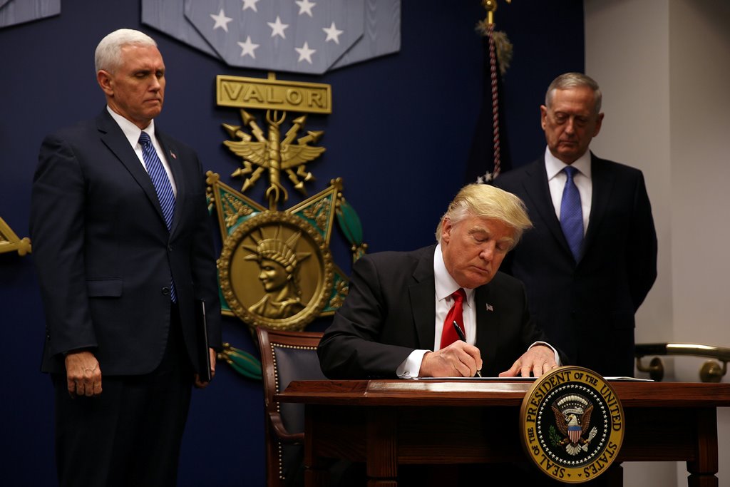 US President Donald Trump signs an executive order he said would impose tighter vetting to prevent foreign terrorists from entering the United States at the Pentagon in Washington, US, January 27, 2017. REUTERS/Carlos Barria