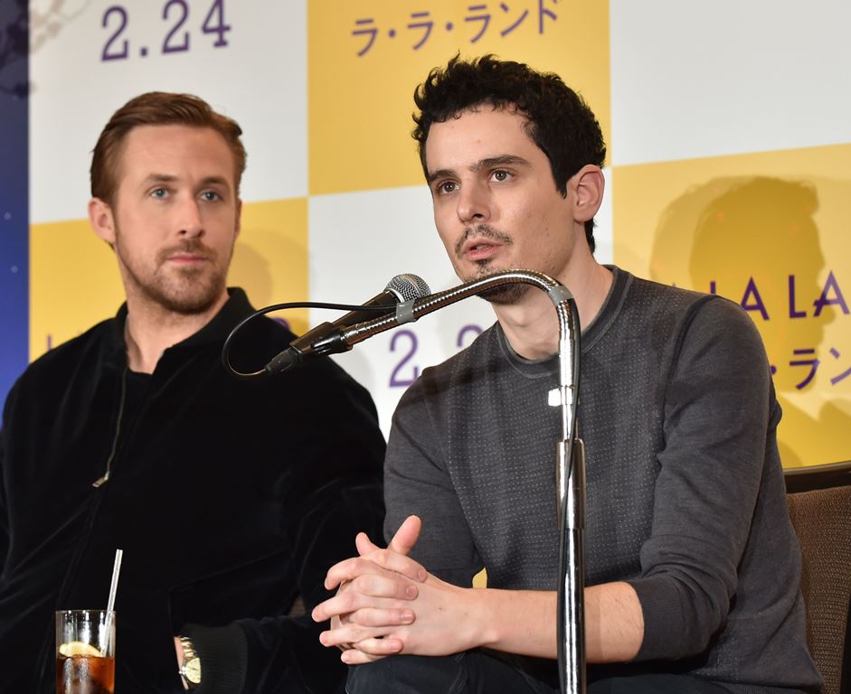 US film director Damien Chazelle (R) answers questions as Canadian actor Ryan Gosling (L) looks on during a press conference for their film 