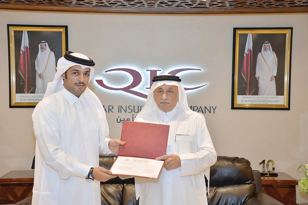 Salem Al Mannai, Deputy Group President & CEO of QIC Mena receives certificate of appreciation from Khalifa Turki Al Subaey, Group President & CEO of QIC Group.