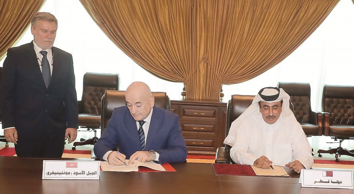 Minister of Transport and Communications H E Jassim Saif Ahmed Al Sulaiti (right)and Montenegrin Minister of Transport and Maritime Affairs Osman Nurkovic signing the deal yesterday.