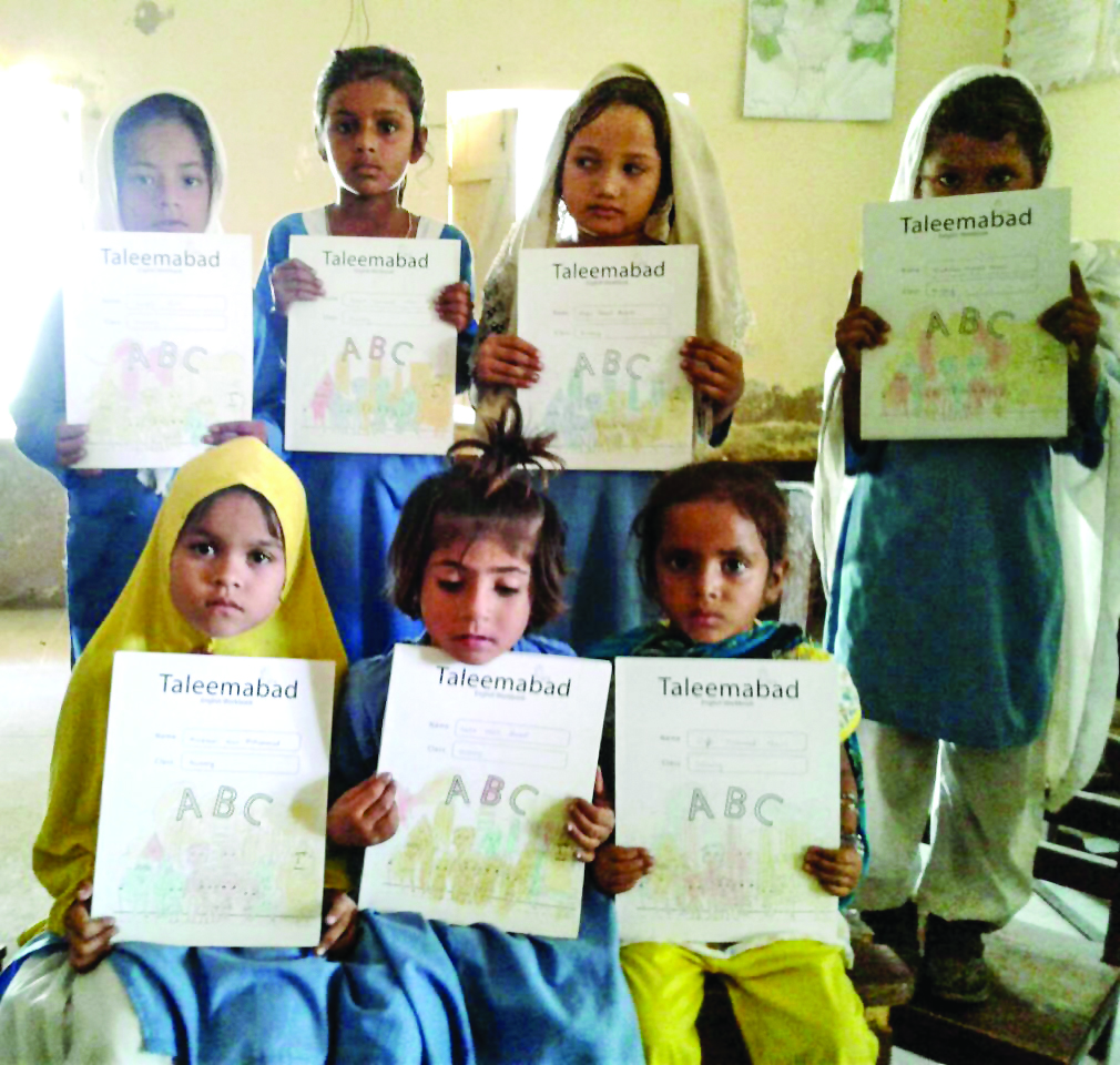 Students in Pakistan with the books that accompany Orenda's educational Taleemabad cartoon programme.