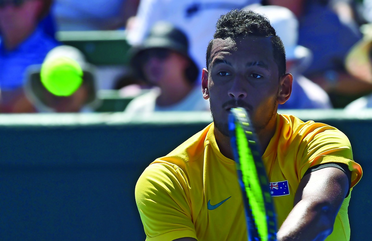 Nick Kyrgios of Australia hits a return against Jan Satral of the Czech Republic during their Davis Cup world group first round match at Kooyong in Melbourne yesterday. 