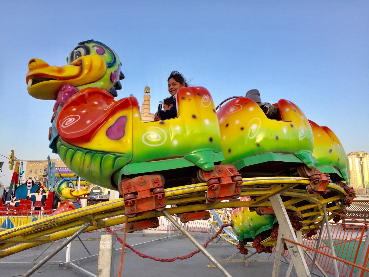 Children enjoy Caterpillar ride at Al Ahmed Square on the last day of Souq Waqif Spring Festival yesterday. Pic: Raynald C Rivera / The Peninsula
