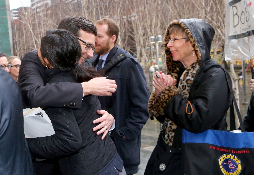 Washington state Attorney General Bob Ferguson hugs people outside the courthouse after a press conference at the U.S. District Court, Western Washington, on February 3, 2017 in Seattle, Washington. Karen Ducey/AFP