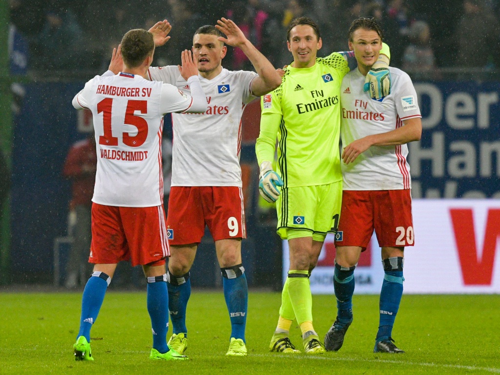 This picture taken on February 3, 2017 shows Hamburg's Greek defender Kyriakos Papadopoulos (2nd L) celebrating with team mates after the German first division Bundesliga football match between Hamburger SV and Bayer 04 Leverkusen in Hamburg, northern Ger