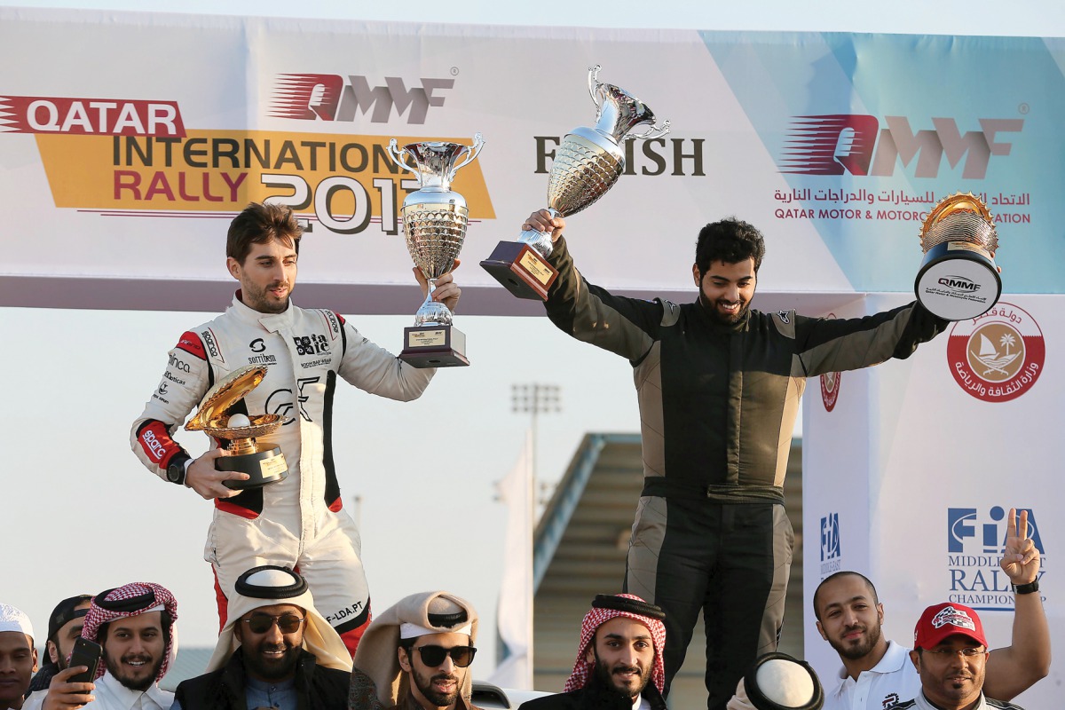 Rashed Al Naimi and Hugo Magalhaes celebrate their win at the Qatar International Rally, the first round of the FIA Middle East Rally Championship, in Doha yesterday. 
