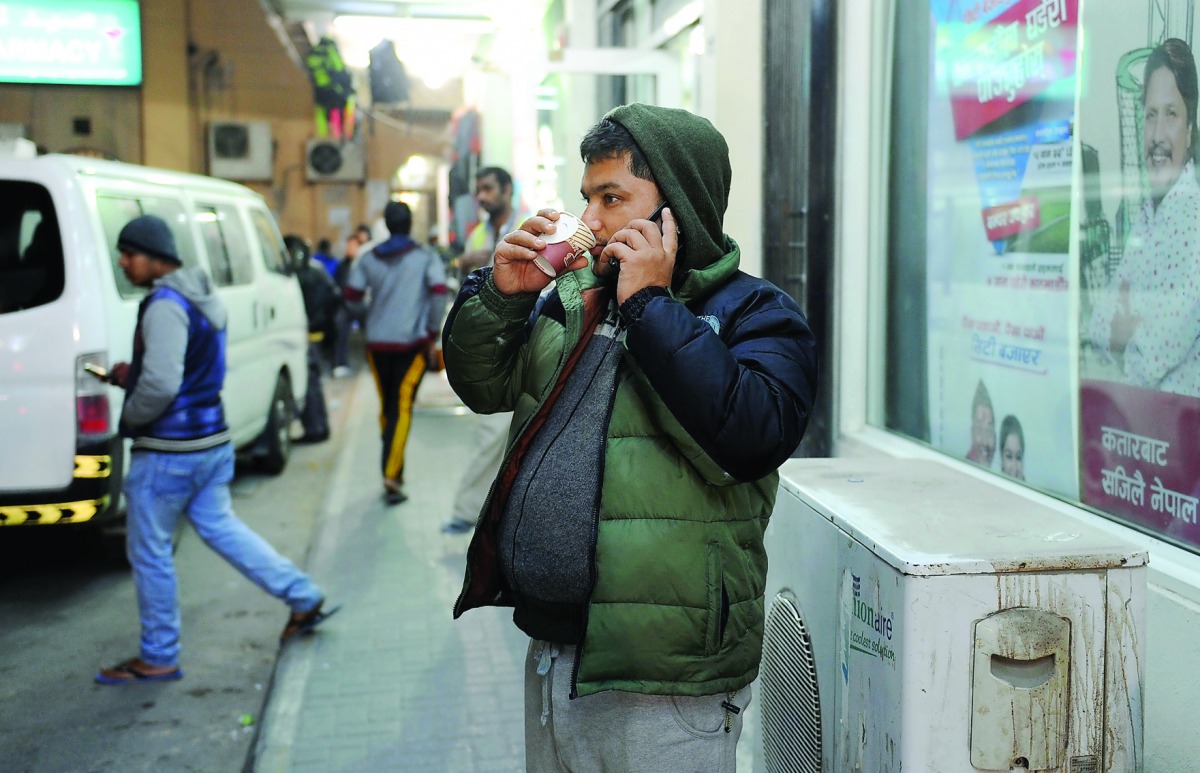 A man sips tea at a cafe in Industrial Area yesterday. People took to the outdoors covered in warm clothes as sunshine brought some relief from chilly conditions on Friday. Pic: Salim Matramkot/The Peninsula