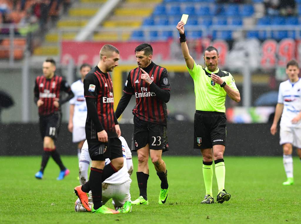 AC Milan Argentinian midfielder Jose Ernesto Sosa (C) receives a yellow card during the Italian Serie A football match AC Milan vs Sampdoria at 