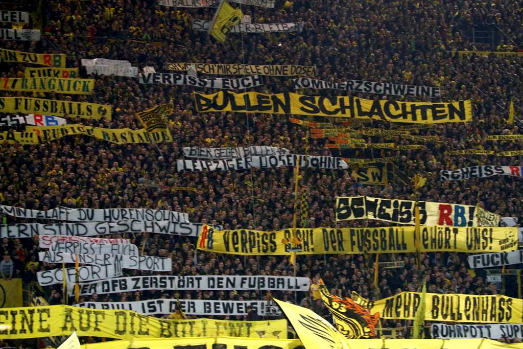 Borussia Dortmund's fans hold banners and cheer during the game. REUTERS/Wolfgang Rattay 

