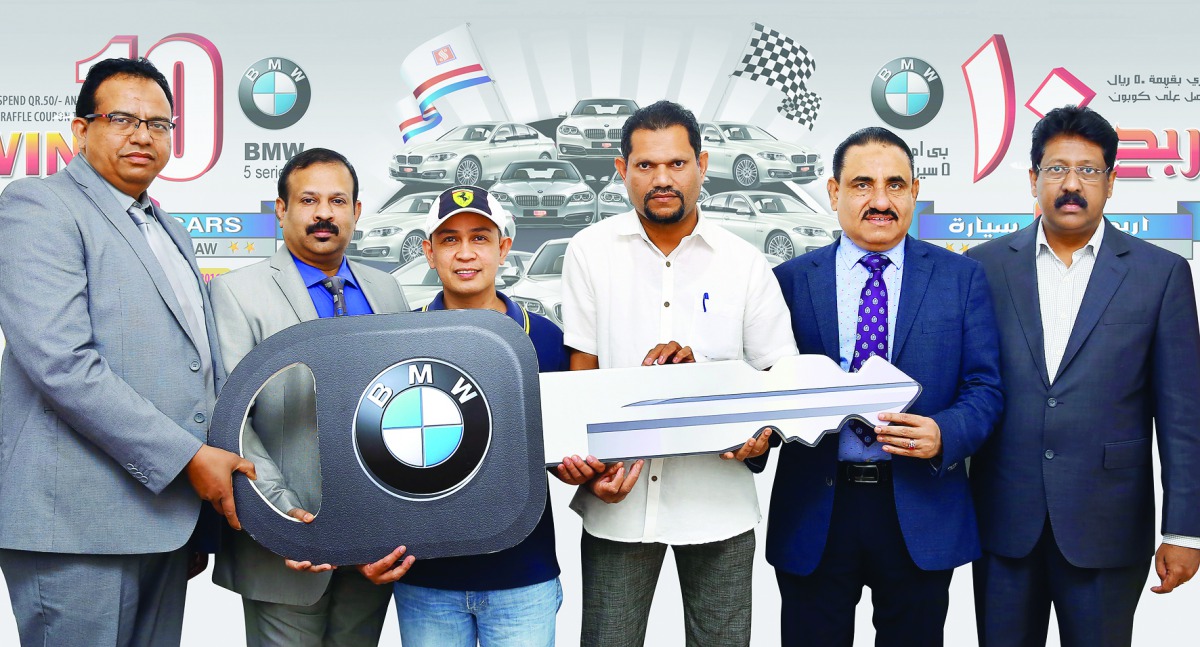 Winners of Safari Win 10 BMW 5 series car promotion third lucky draw, Romeo Jr Laloma Marcado and Musthafa CK receiving the key from Zainul Abideen, Director and General Manager, Safari Group, along  with other Safari officials at a ceremony held at Safar