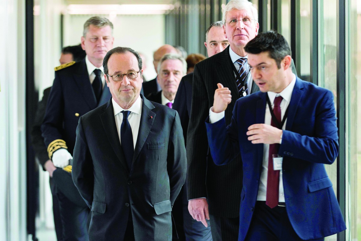 French President Francois Hollande (left) visits the new Pole ECOTOX, a scientific platform specialized in environmental toxicology and eco-toxicology research yesterday, at the business park Rovaltain in Alixan, near Valence, southeastern France.