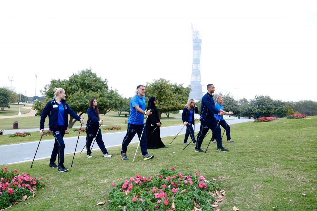 People practice Nordic Walking at Aspire Zone. 