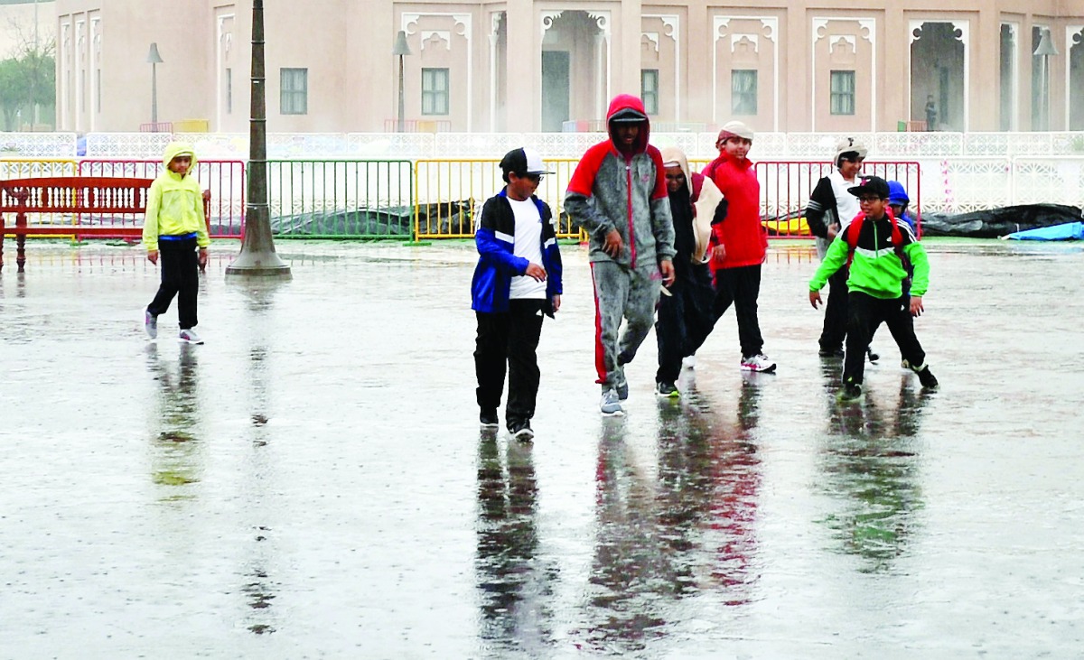 People enjoying the rain at Katara yesterday.  Pic: Kammutty VP / The Peninsula