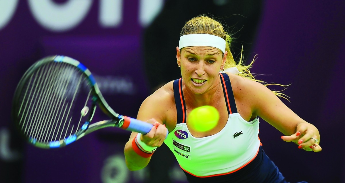 Dominika Cibulkova of Slovakia hits a return to  Russia's Anastasia Pavlyuchenkova during their Qatar Total Open second round match at the Khalifa International Tennis Complex in Doha yesterday. Cibulkova stormed into the quarterfinals with a 7-5, 2-6, 6-