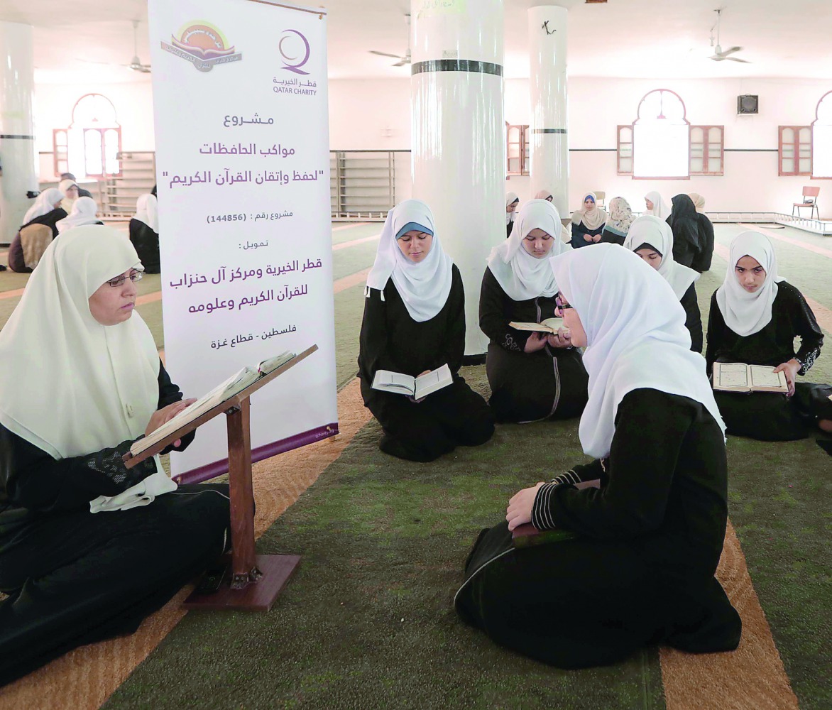 Girls and women participating at a Holy Quran reciting and memorising programme organised by Qatar Charity in Gaza.