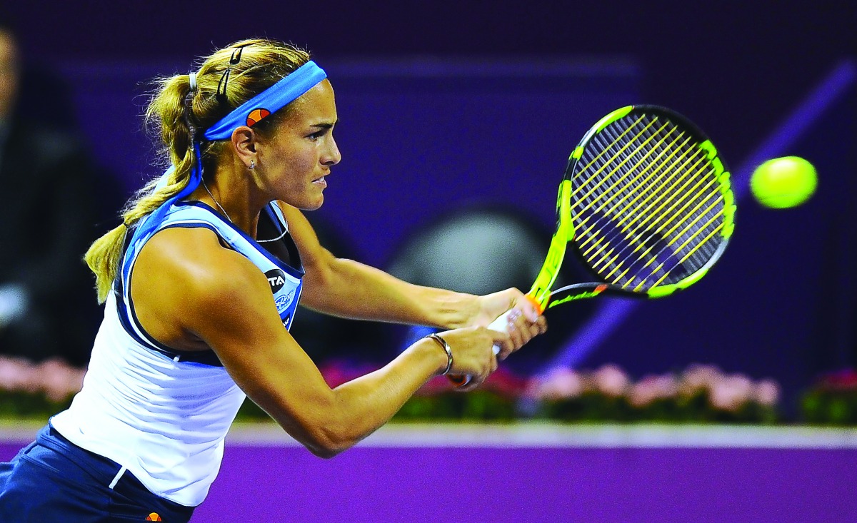 Puerto Rican Olympic champion  Monica Puig returns a shot to Russian teenager  Daria Kasatkina during their Qatar Total Open  Quarter-final played at the Khalifa International Tennis  Complex in Doha yesterday. Puig made a remarkable  fight back to beat K