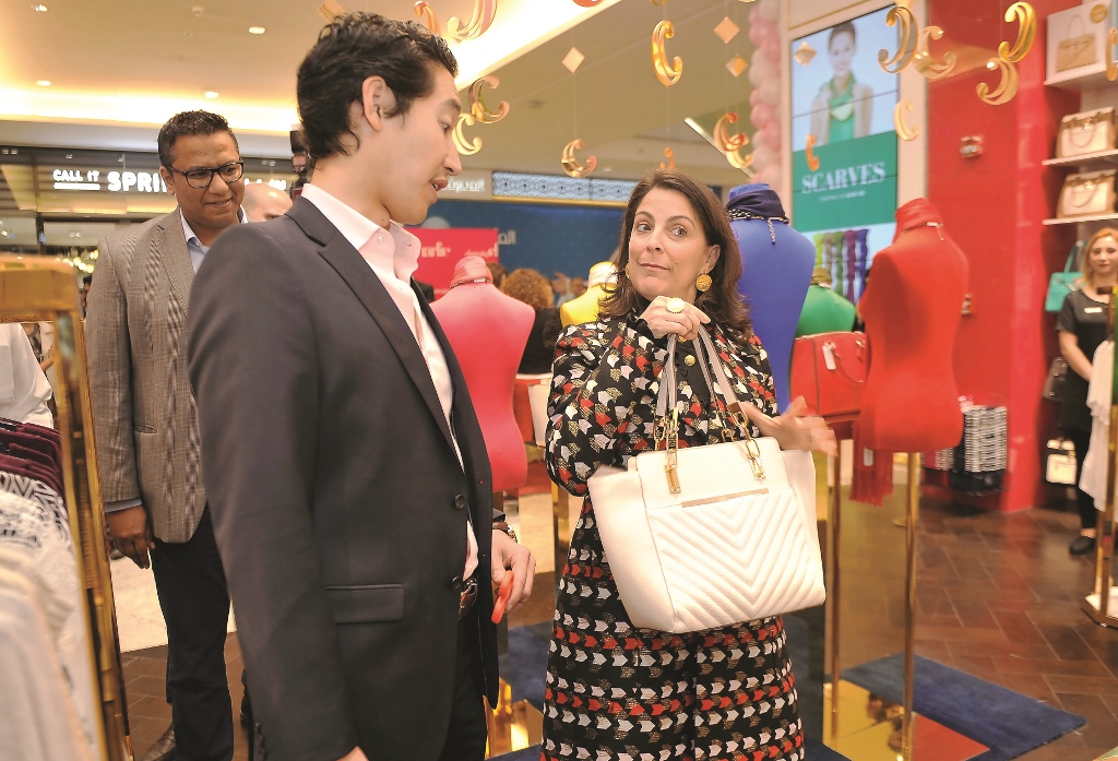 US Ambassador Dana Shell Smith admires a product with Charlie Chanaratsopon, Founder and Chief Executive of Charming Charlie, at the opening of the brand's new outlet at Mall of Qatar on Wednesday. Pic: Abdul Basit/ The Peninsula