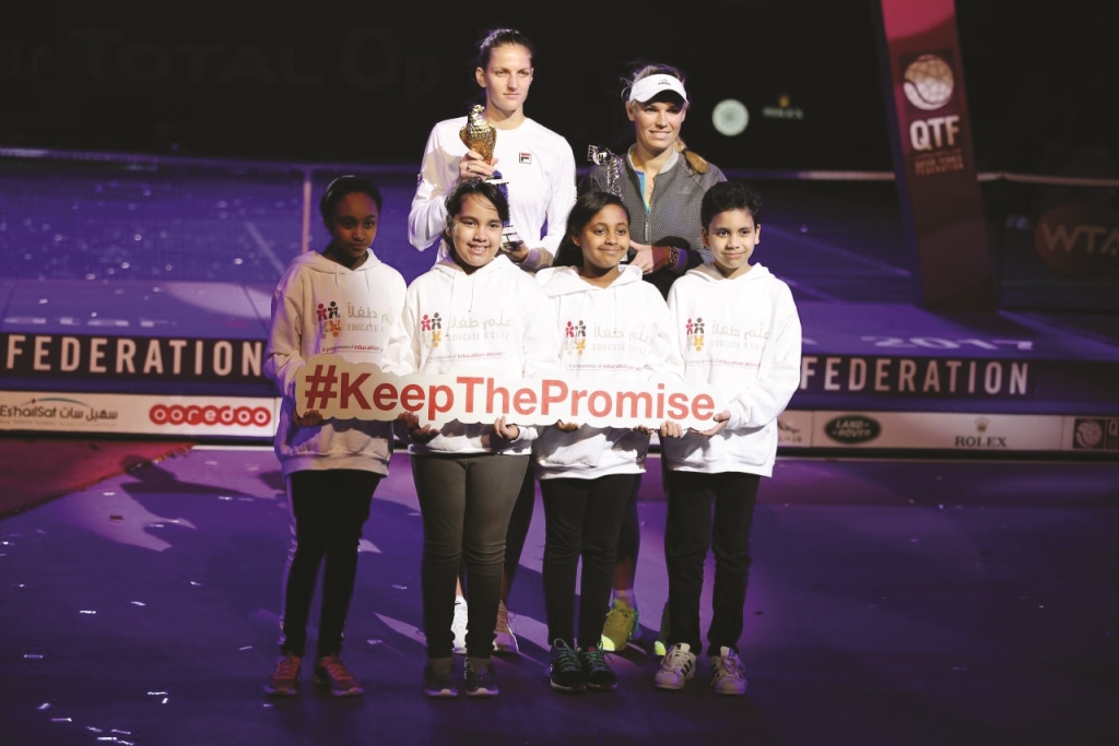 Young supporters of Educate A Child programme with Qatar Total winner Karolina Pliskova and runner-up Caroline Wozniacki.