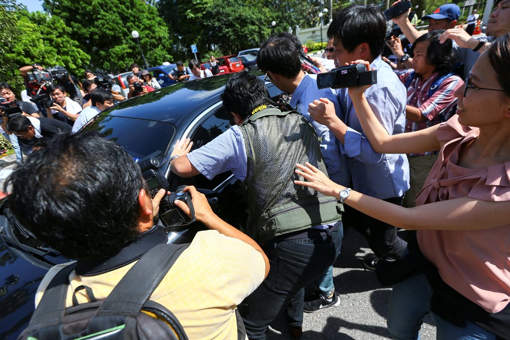 Members of the media chase a North Korean official car to ask questions at the Foreign Ministry in Putrajaya, Malaysia, February 20, 2017. REUTERS/Athit Perawongmetha
